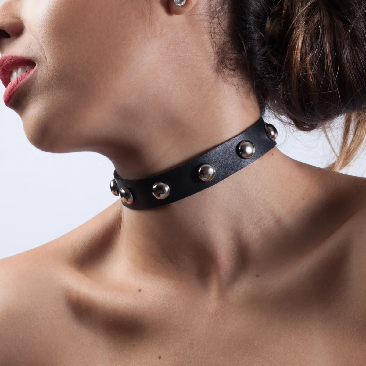 Bold leather choker with silver-tone dome studs.
